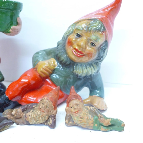 717 - Eight 1950's pottery gnomes, two standing, six reclining