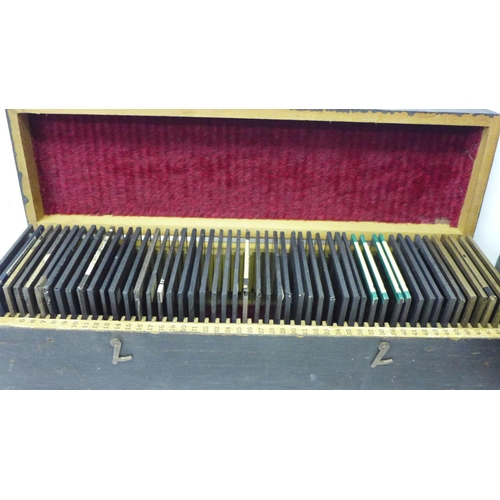 802 - A magic lantern and a collection of 50 magic lantern slides