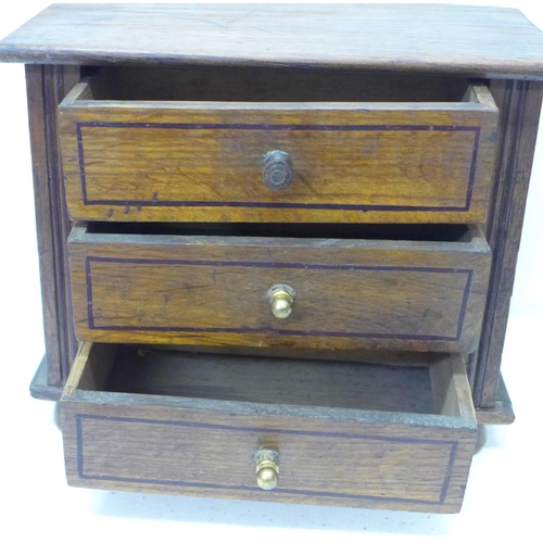 821 - A miniature oak chest of three drawers, 28cm x 23cm