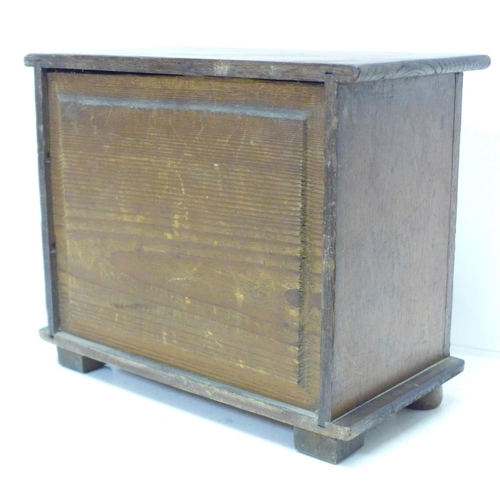 821 - A miniature oak chest of three drawers, 28cm x 23cm