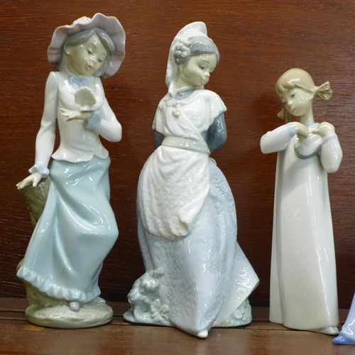 830 - Four Nao/Lladro figurines. “Listening to the Bird Song” (ref 02001042), “Girl Holding Dove” (ref 020... 