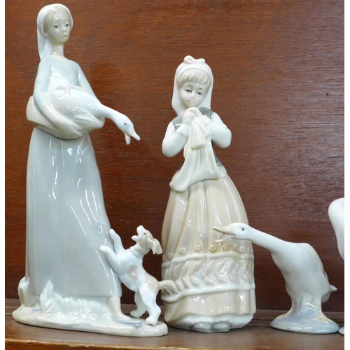 831 - Four Nao/Lladro figurines and one other, including “Girl with Goose and Dog”, “Girl with Puppy” and ... 