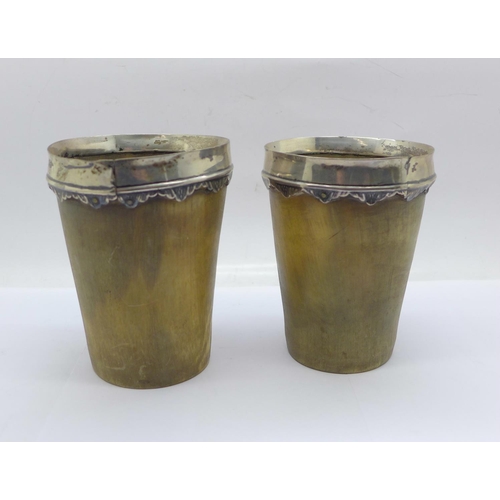 852 - A pair of 19th Century white metal mounted horn cups, 10.5cm