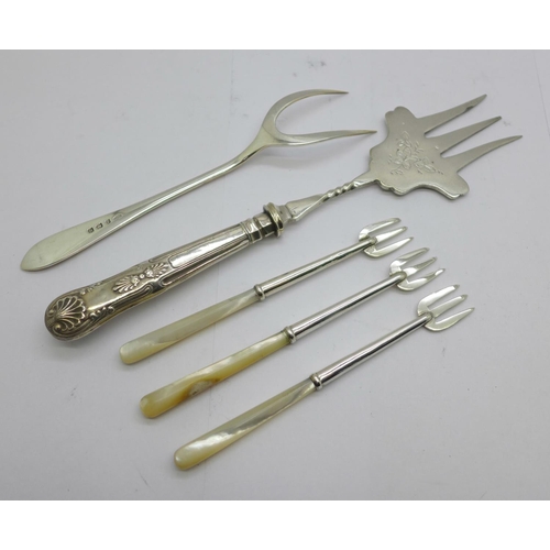 857 - A silver bread fork, Birmingham 1936, one other bread fork with silver covered handle and three silv... 