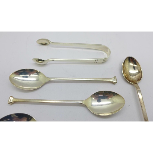 875 - Five silver coffee spoons, a silver commemorative spoon and a pair of silver sugar bows, 63g