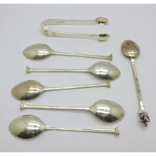 875 - Five silver coffee spoons, a silver commemorative spoon and a pair of silver sugar bows, 63g