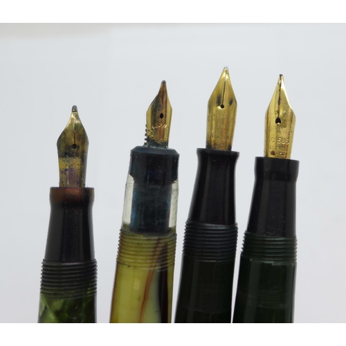 881 - Four fountain pens with 14ct gold nibs, Waterman's, Swan, The Unique Pen lacking end cap and one in ... 