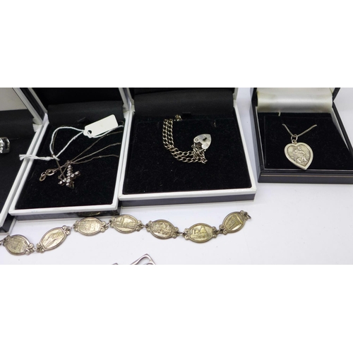 900 - A collection of mainly silver jewellery, etc., including two charm bracelets, chains, pendants inclu... 