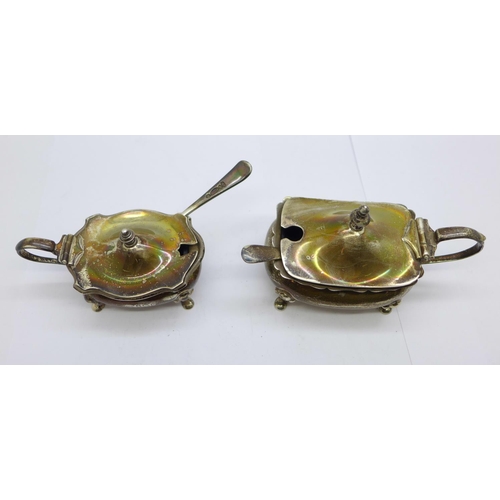 917 - Two silver mustard pots with blue glass liners, one by Walker & Hall, Birmingham 1918, and one by Ad... 