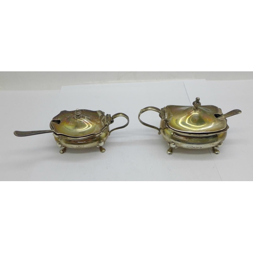 917 - Two silver mustard pots with blue glass liners, one by Walker & Hall, Birmingham 1918, and one by Ad... 