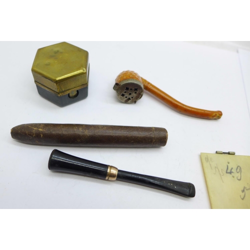 934 - A travel inkwell, a thermometer, a cigarette holder, a pipe and a note book