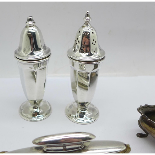 943 - A pair of silver salt and pepper pots, two silver salts and a silver mounted buffer by Goldsmiths & ... 