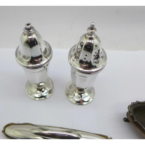 943 - A pair of silver salt and pepper pots, two silver salts and a silver mounted buffer by Goldsmiths & ... 