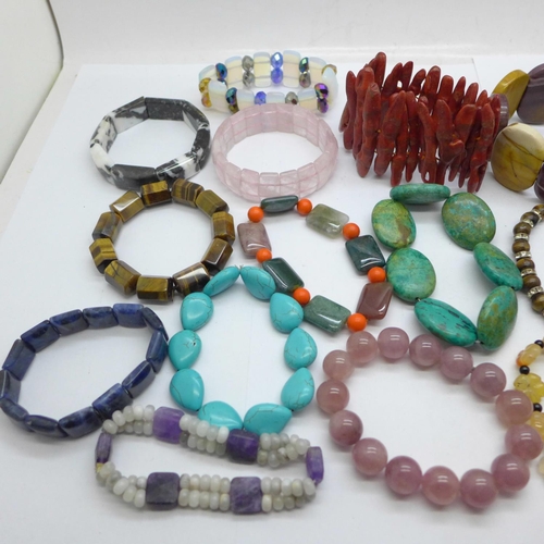 975 - Gemstone bracelets including opalite, coral, tigers eye, etc.