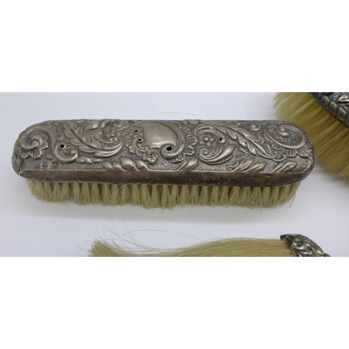 987 - Two silver backed brushes and a silver mounted brush, clothes brush a/f