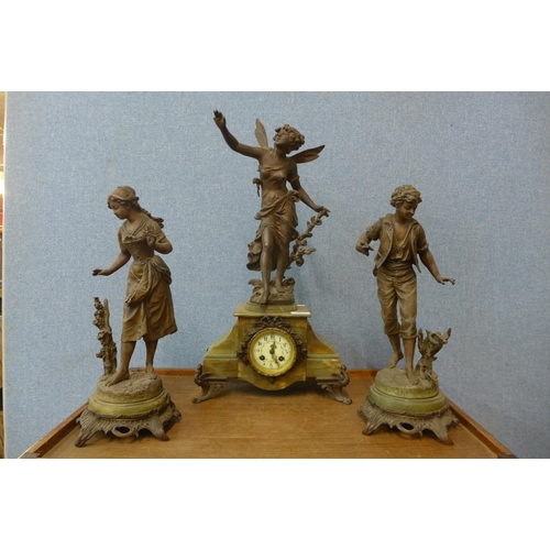 20 - A French onyx and spelter figural clock garniture, the movement signed Marti & Cie.