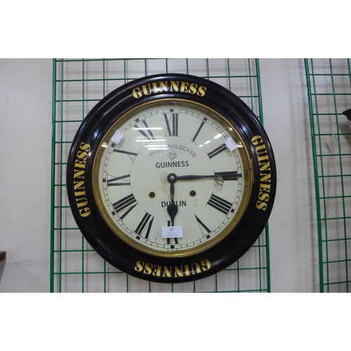 21 - An Ansonia Clock Co. circular wall clock, bearing later Guinness inscription