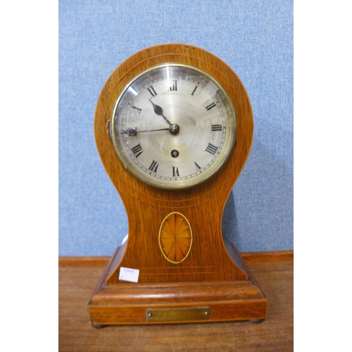 24 - An early 20th Century inlaid oak balloon shaped mantel clock