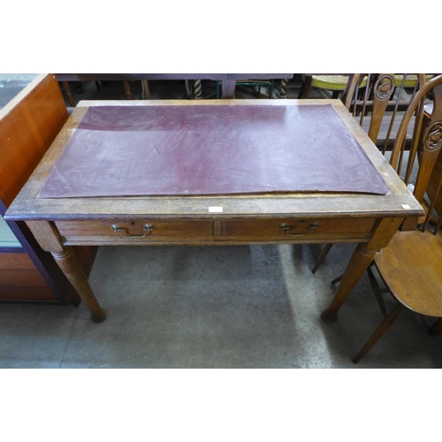 53 - An Edward VII oak two drawer library table