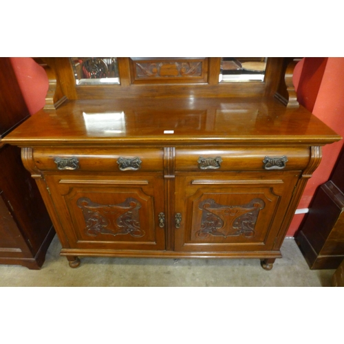 68 - An Edward VII carved walnut mirrorback sideboard