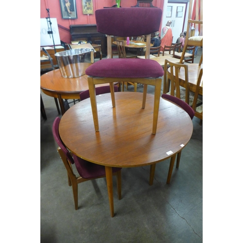 599 - A teak circular dining table and four chairs