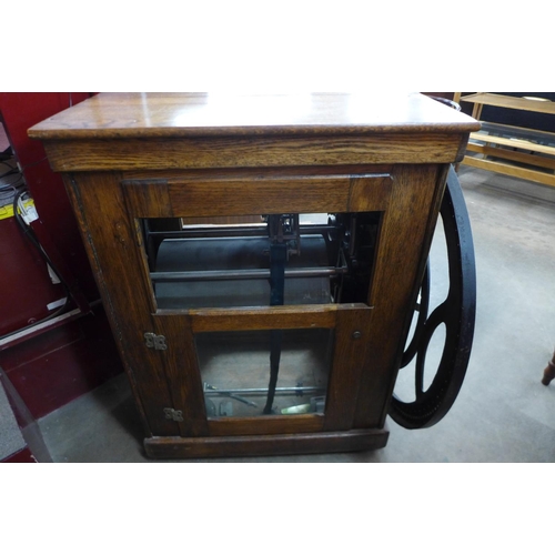 77 - An American oak and iron clocking in machine