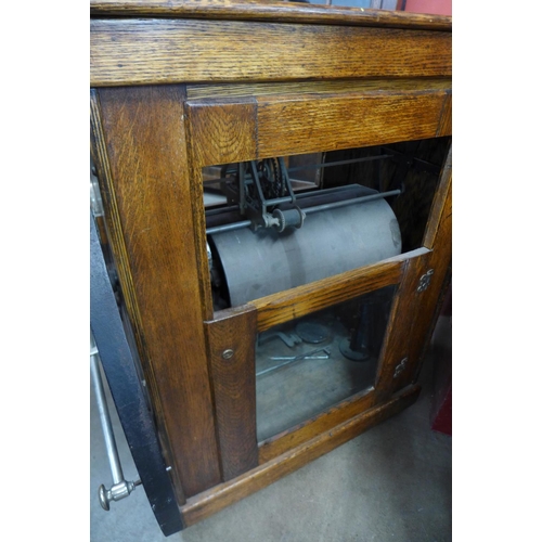 77 - An American oak and iron clocking in machine