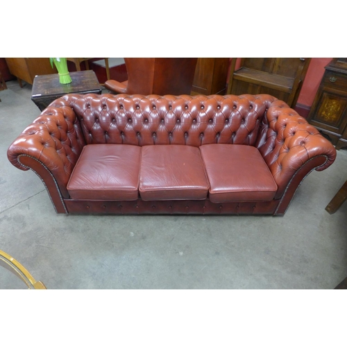 89 - A red leather Chesterfield settee