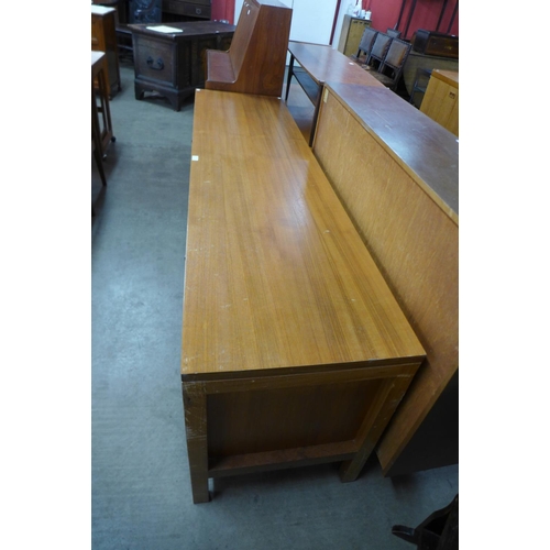 116 - A teak sliding two door sideboard