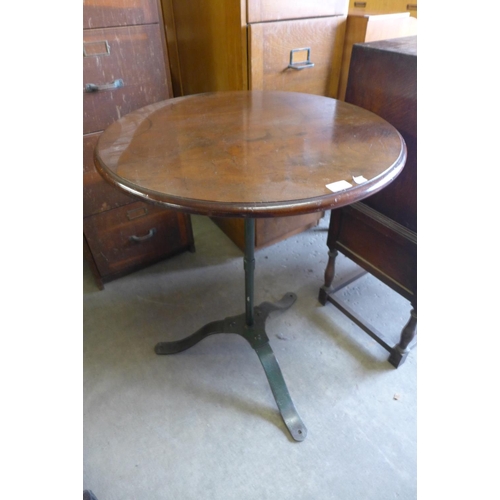 174 - A mahogany and wrought steel based pub table