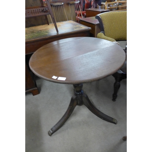 212 - An oak circular tripod table