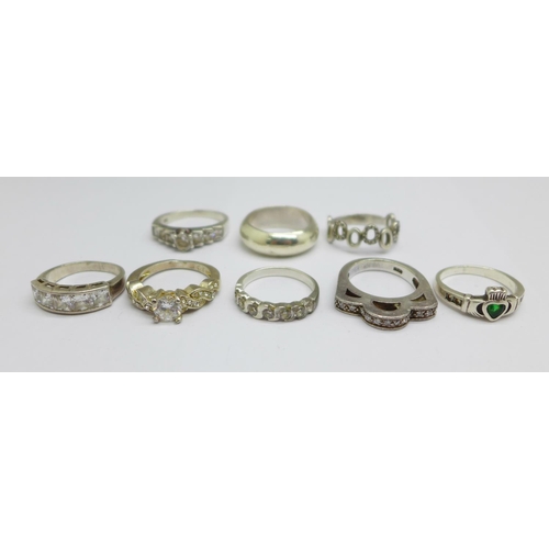 1030 - Eight silver rings, one lacking stones