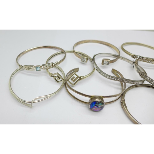 1046 - Seven silver bangles and three white metal bangles, total weight 117g