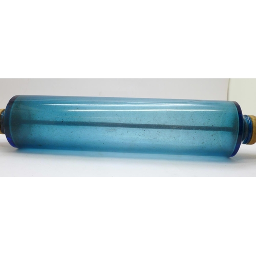 664 - A glass rolling pin with wooden handles