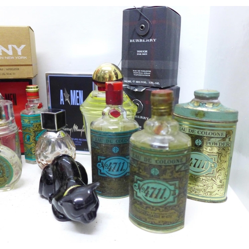 686 - A collection of perfume bottles including 4711, etc., (lacking contents) and a shop display bottle