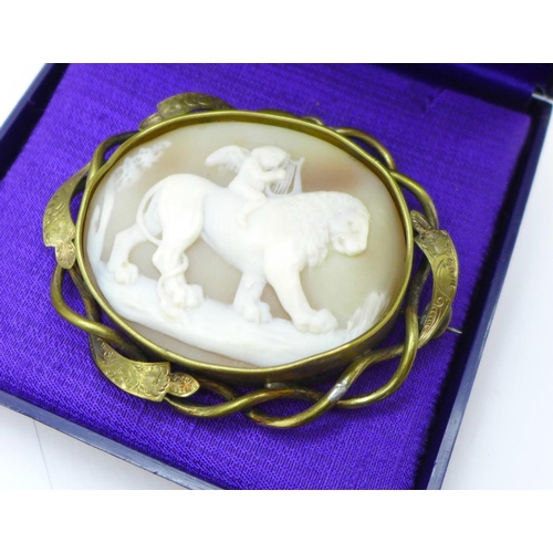 692 - Two photographs in frames, plated items and a carved cameo brooch of a cherub sitting on a lion