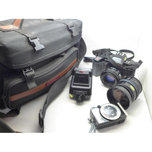 733 - A Minolta 5000 35mm camera, with additional lens, flash, light meter, remote and bag