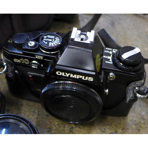 737 - Two Olympus cameras, OM10 and OM40 and five lenses including Olympus, Hanimex and Tokina