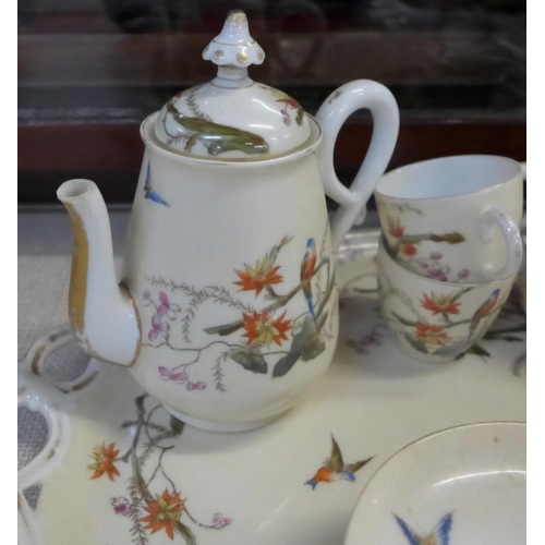 794E - A continental four setting tea set decorated with flora and fauna, parrots and butterflies, with tra... 