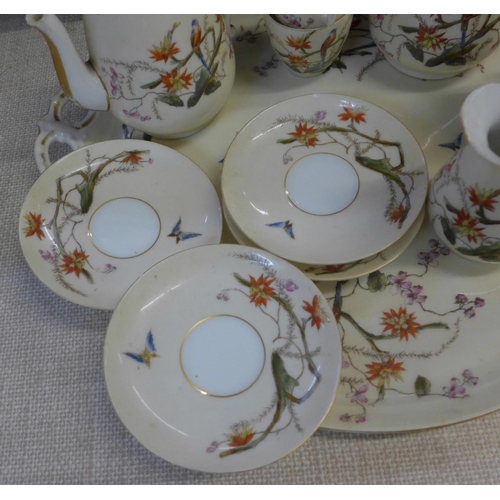 794E - A continental four setting tea set decorated with flora and fauna, parrots and butterflies, with tra... 