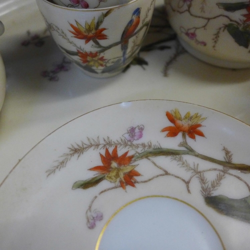 794E - A continental four setting tea set decorated with flora and fauna, parrots and butterflies, with tra... 