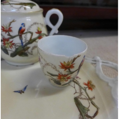 794E - A continental four setting tea set decorated with flora and fauna, parrots and butterflies, with tra... 