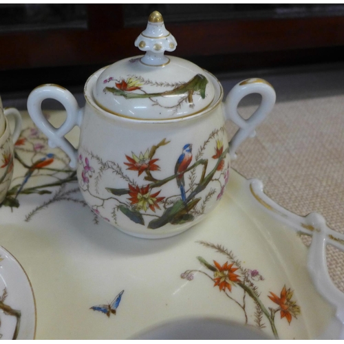 794E - A continental four setting tea set decorated with flora and fauna, parrots and butterflies, with tra... 