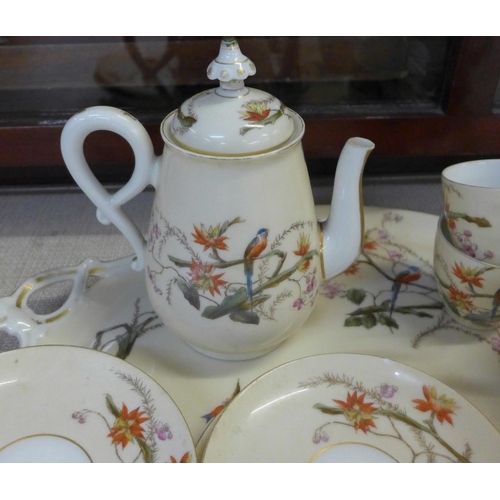 794E - A continental four setting tea set decorated with flora and fauna, parrots and butterflies, with tra... 