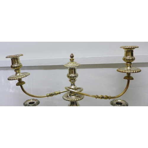 799 - A silver plated candelabra and a pair of plated candlesticks, one candlestick a/f