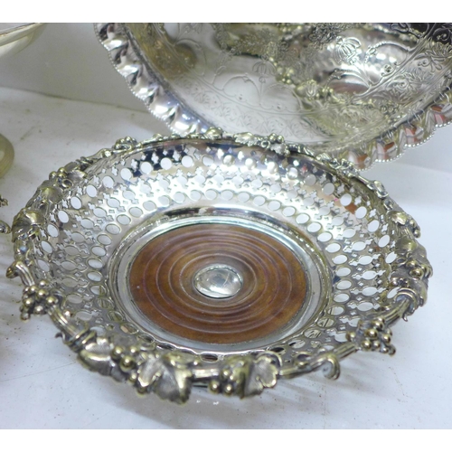 801 - An Art Nouveau silver plated swing handle basket, a plated tray on three ball and claw feet and a pa... 