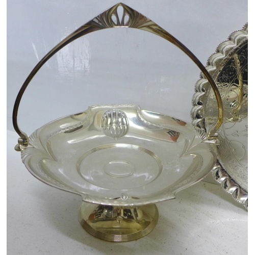 801 - An Art Nouveau silver plated swing handle basket, a plated tray on three ball and claw feet and a pa... 