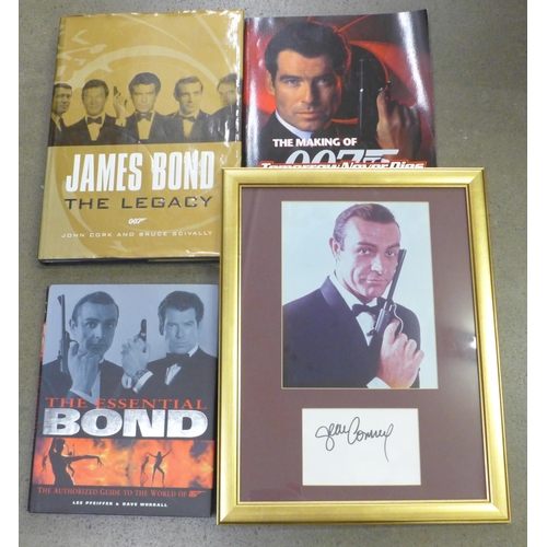 810 - A James Bond photograph with signature, framed, three James Bond books, The Making of 007, The Essen... 