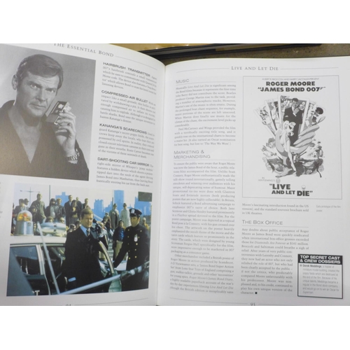 810 - A James Bond photograph with signature, framed, three James Bond books, The Making of 007, The Essen... 