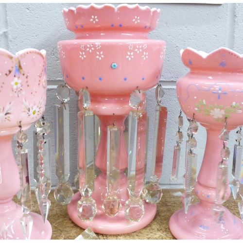 820 - Two similar pink glass lustres and one larger lustre (one drop a/f)